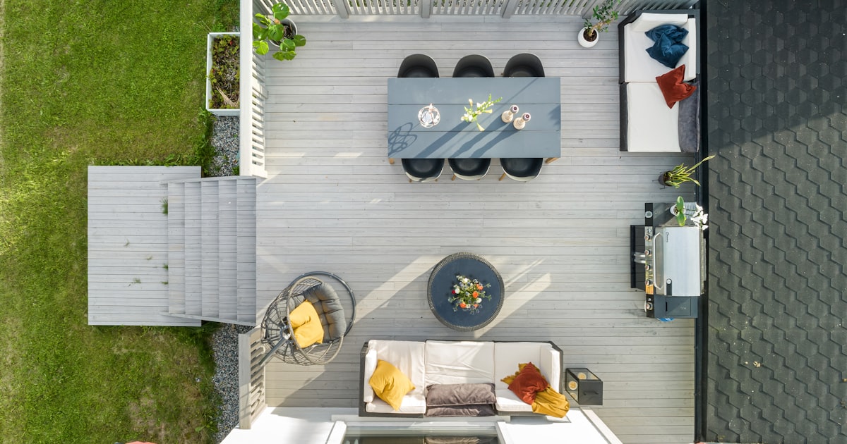 Aerial view of a finished backyard patio with dining and seating areas