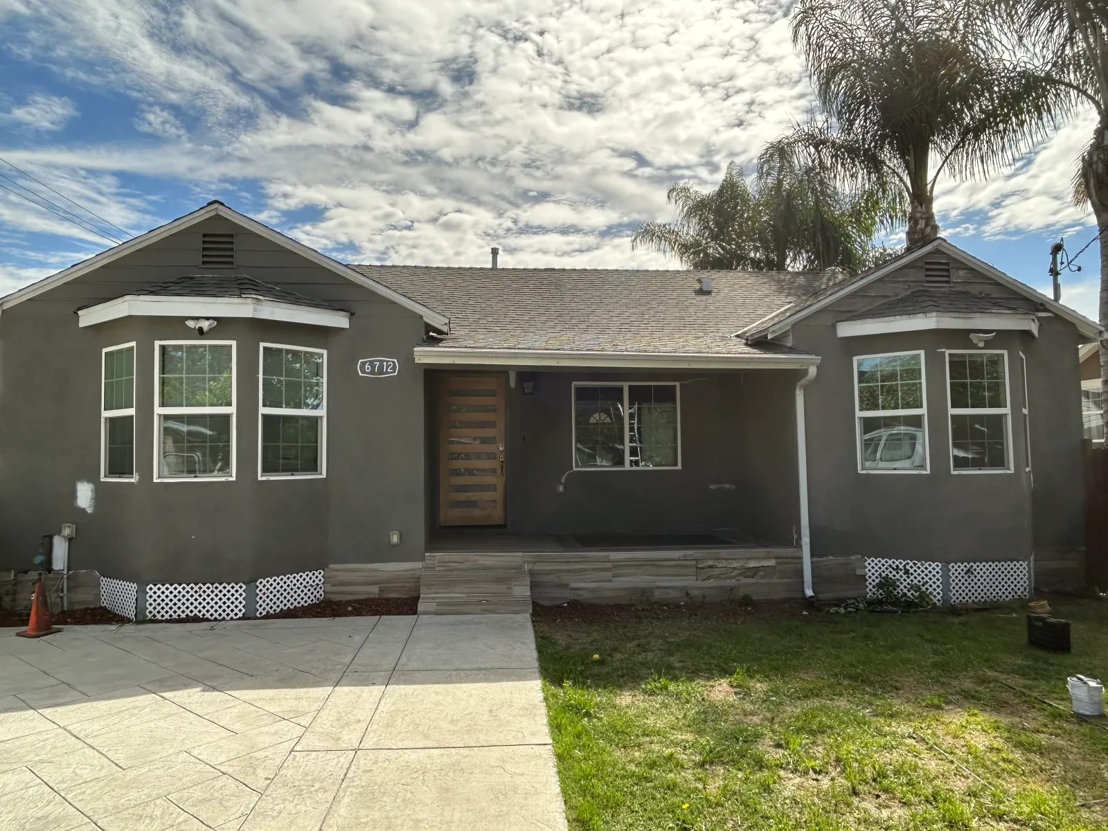 Full exterior home renovation with dark stucco finish