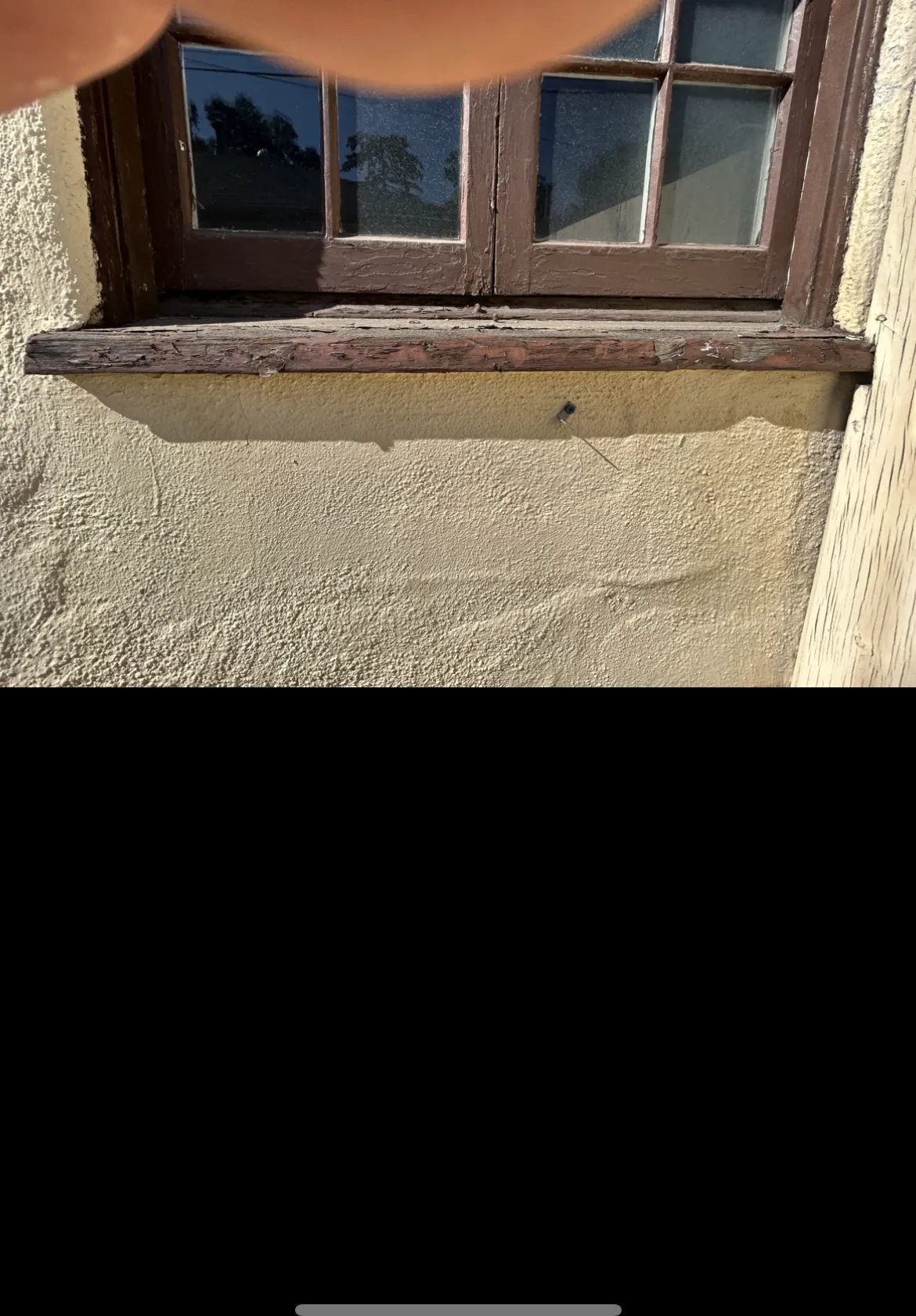 Deteriorated window sill before repair