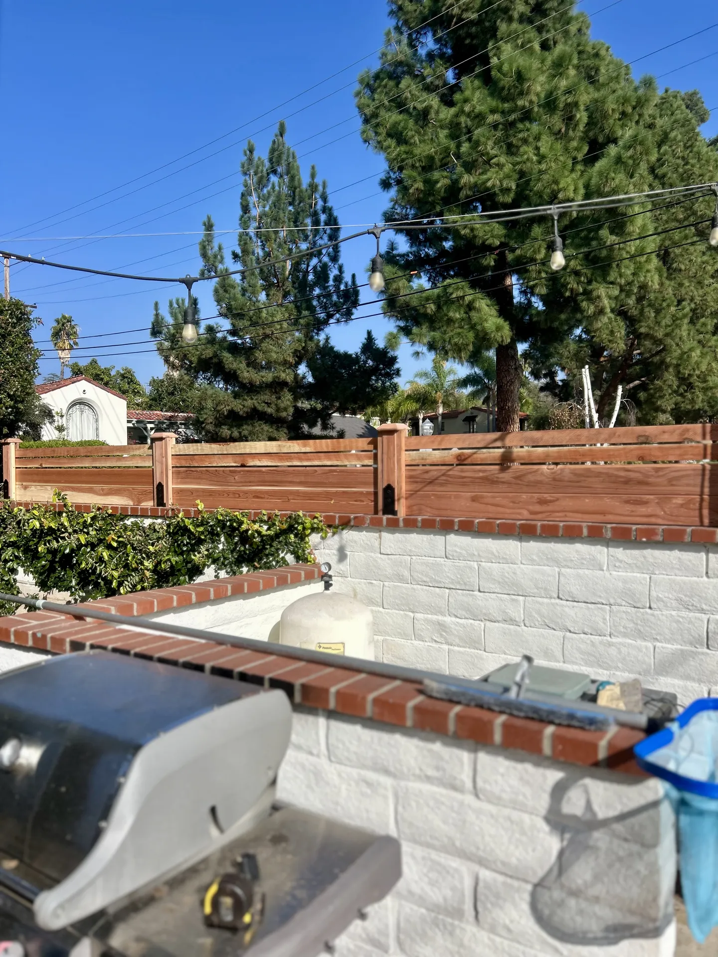 Fence installed atop block retaining wall
