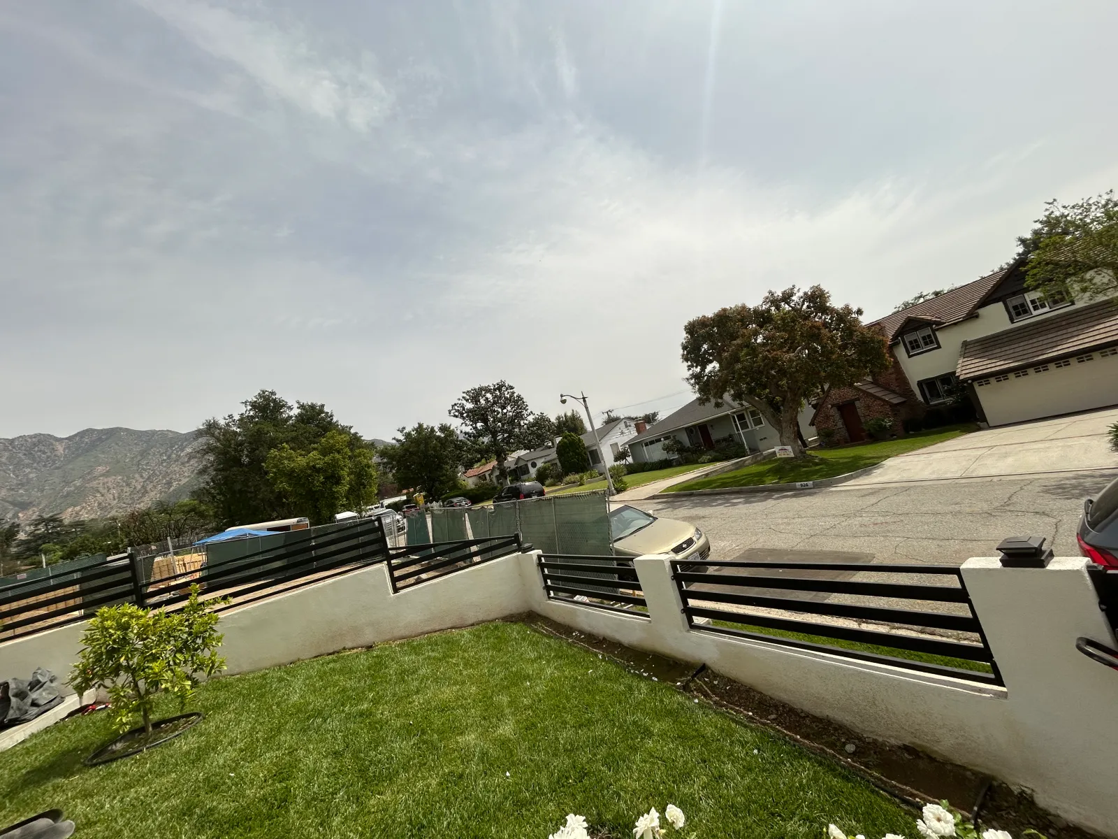 Modern horizontal metal fence with landscaping