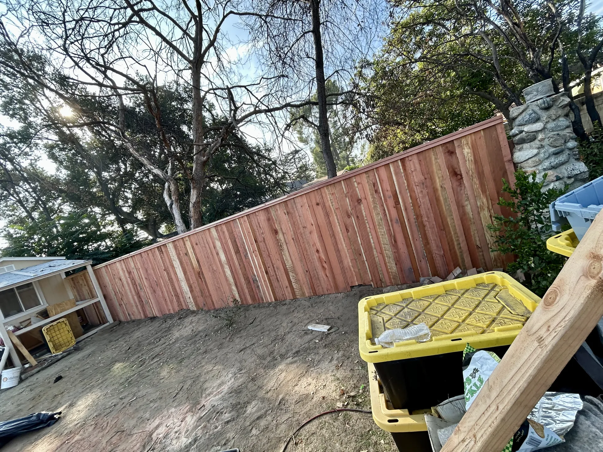 Tall privacy fence on sloped hillside property