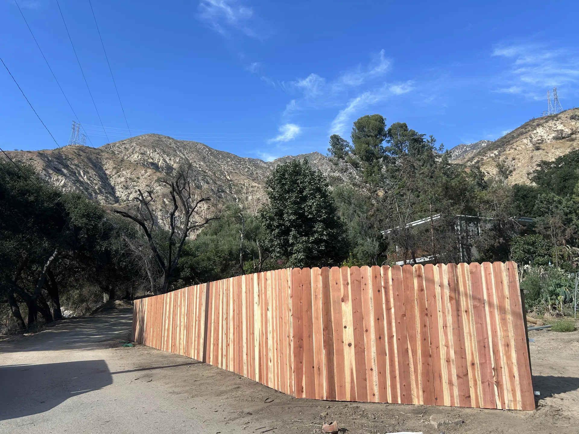 Wide view of completed cedar fence installation