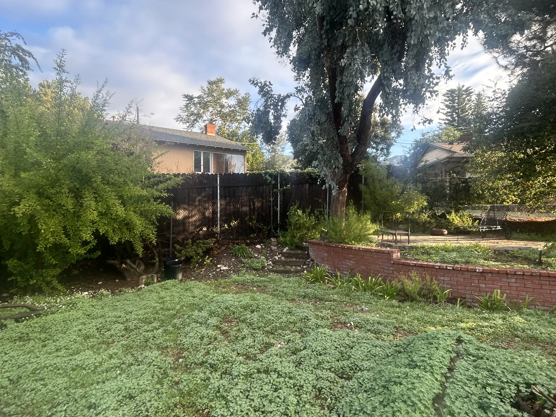 Old chain link on brick wall before fence replacement