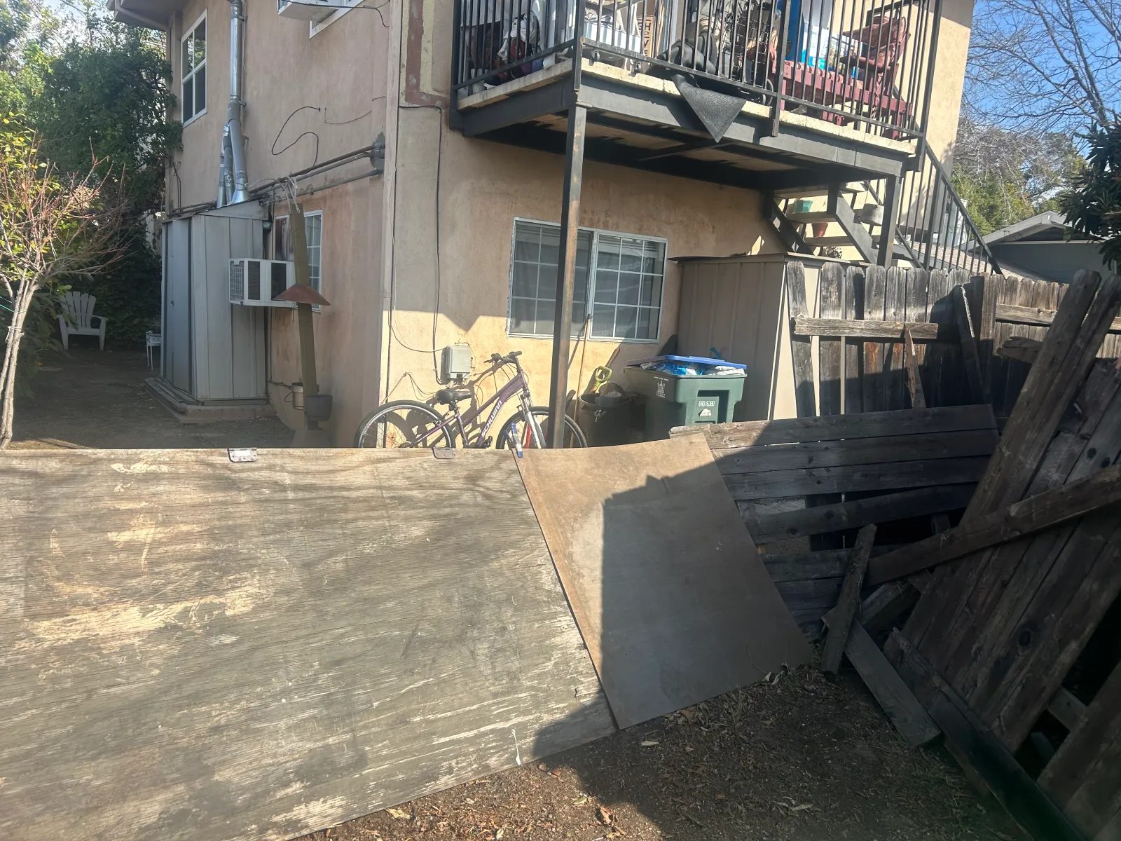 Deteriorated leaning fence before replacement