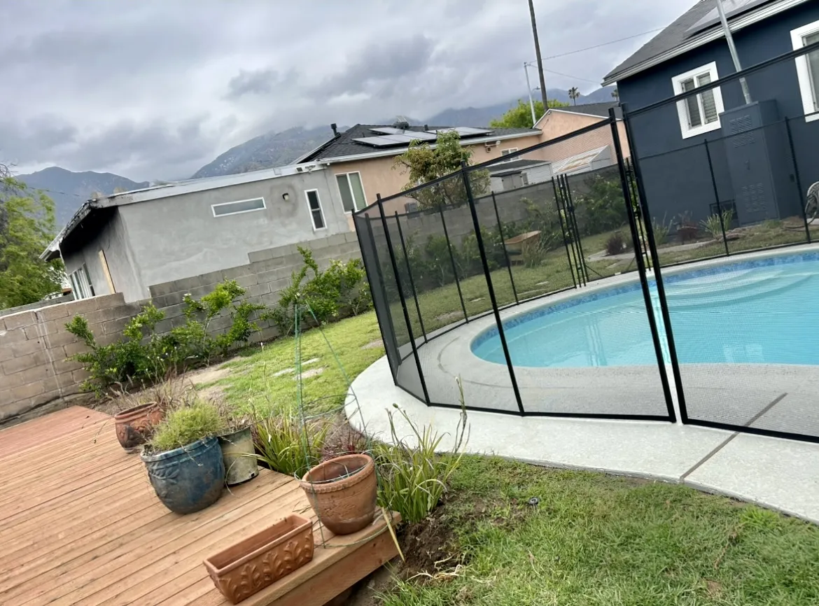 Restored pool with safety fence after fire damage cleanup