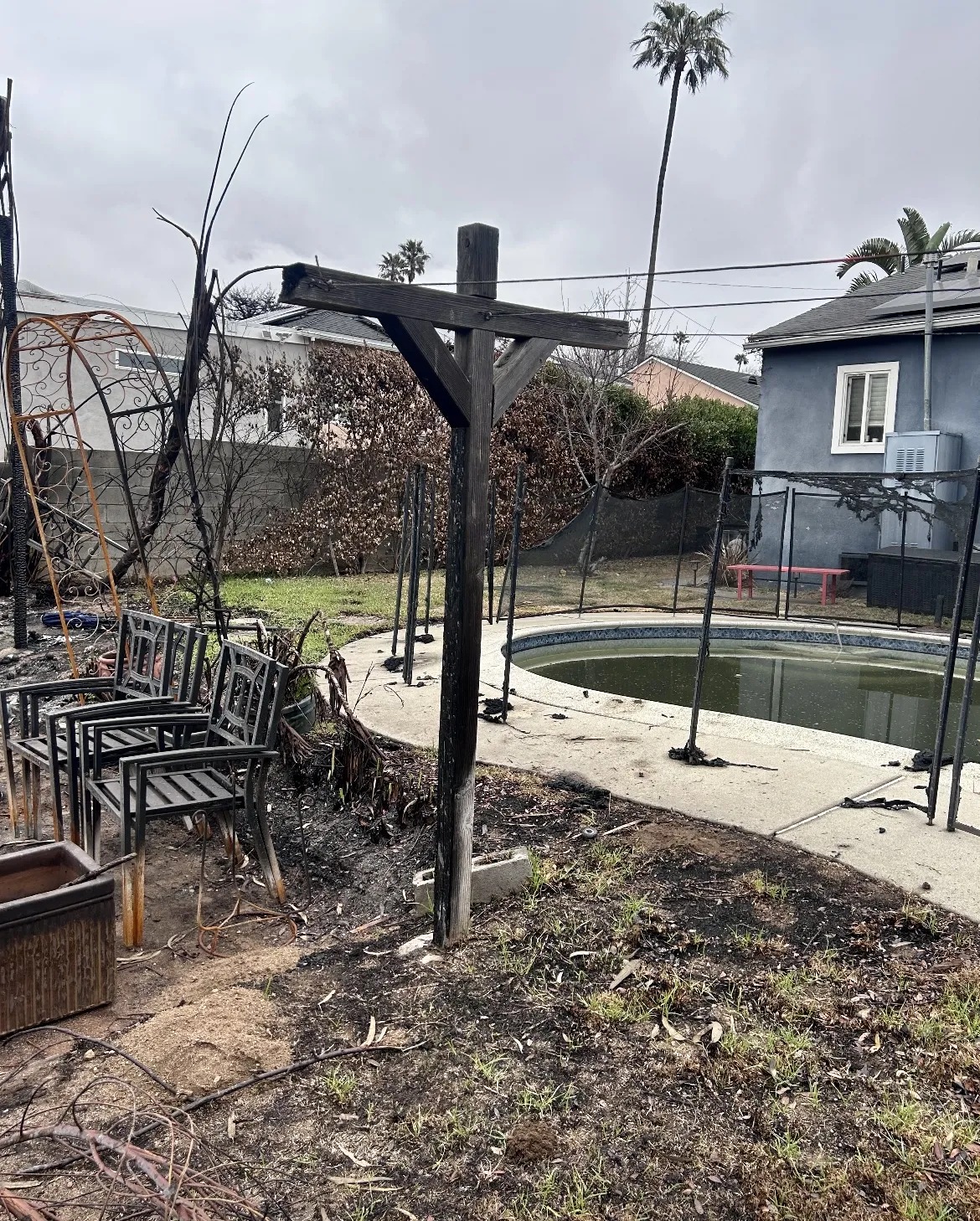 Fire-damaged pool area before restoration