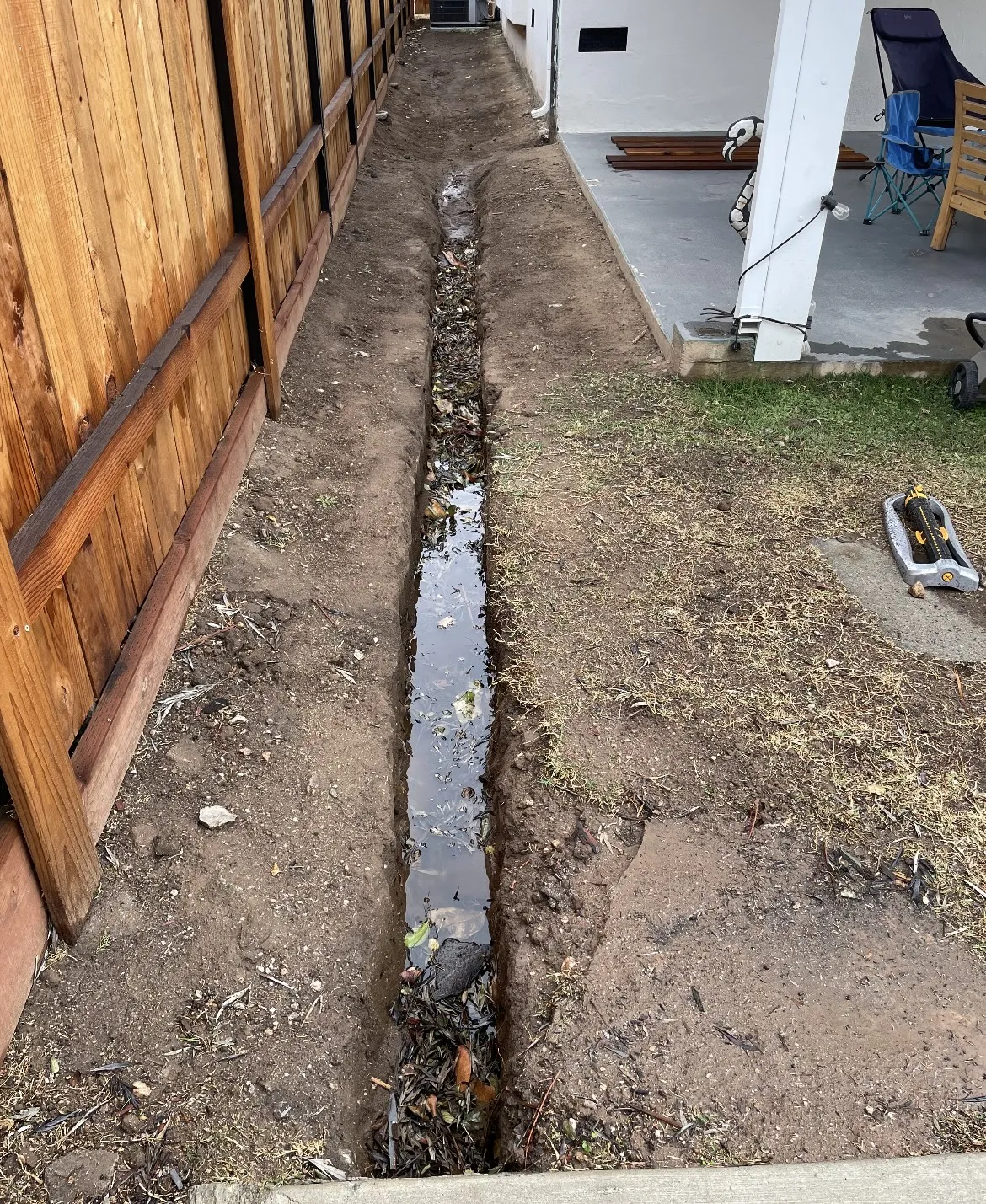 Drainage trench dug along house foundation