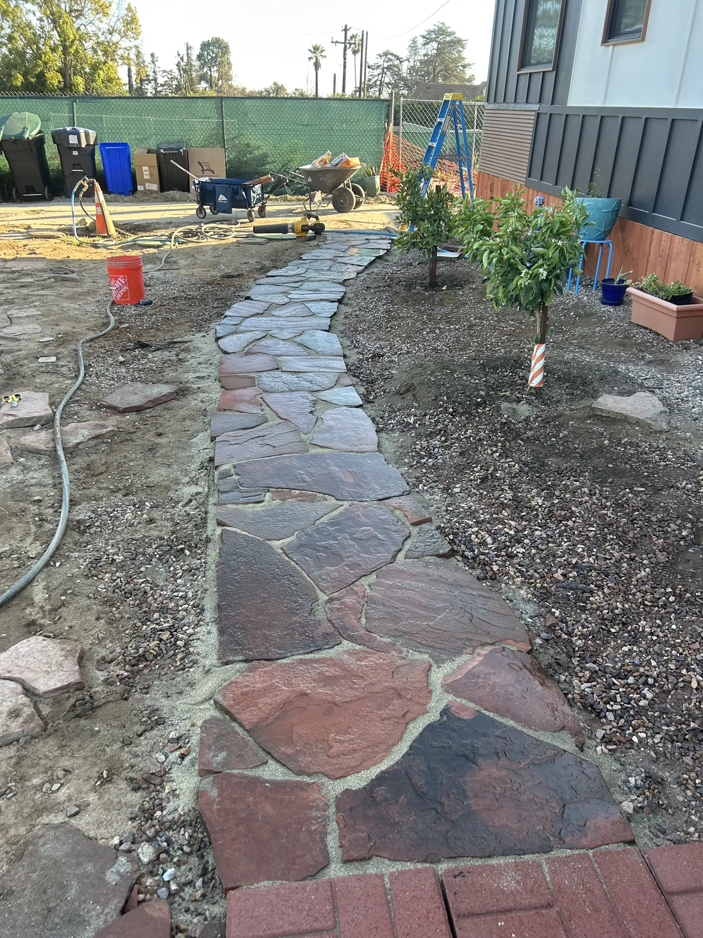 Flagstone being laid on hillside walkway