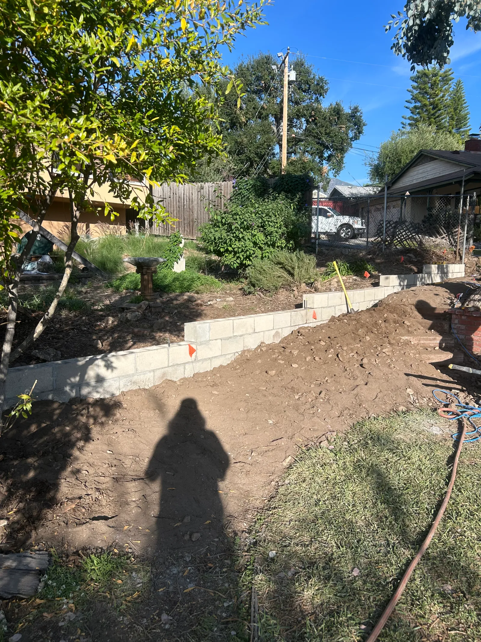 Paver cap stones being laid on retaining wall
